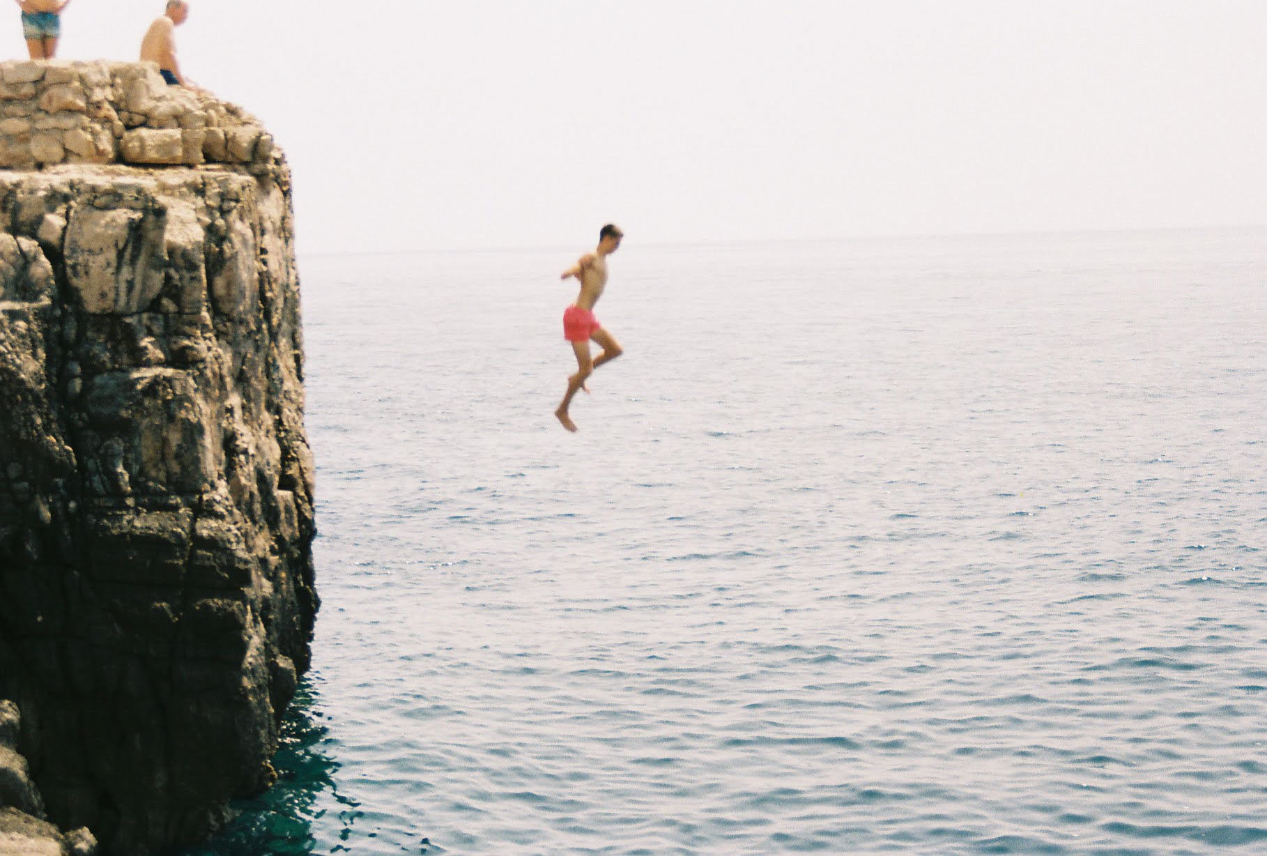 Person jumping from a cliff